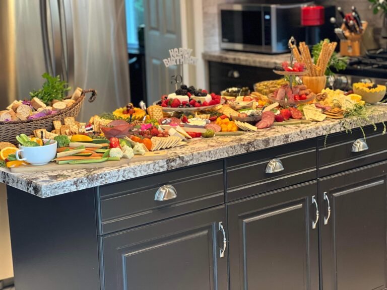 Large grazing table filled with meats, cheeses, fruit, vegetables, crackers and appetizers