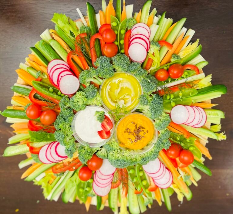 Fresh vegetables arranged with dip on a colorful grazing platter