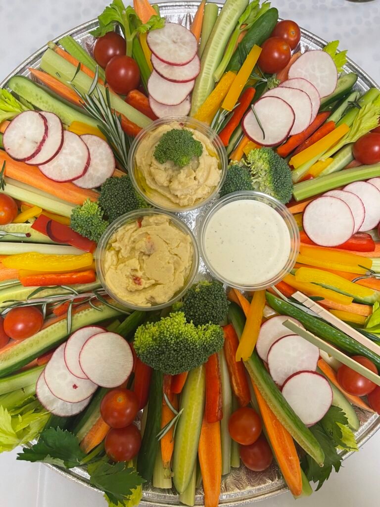 Fresh vegetables arranged with dip on a colorful grazing platter